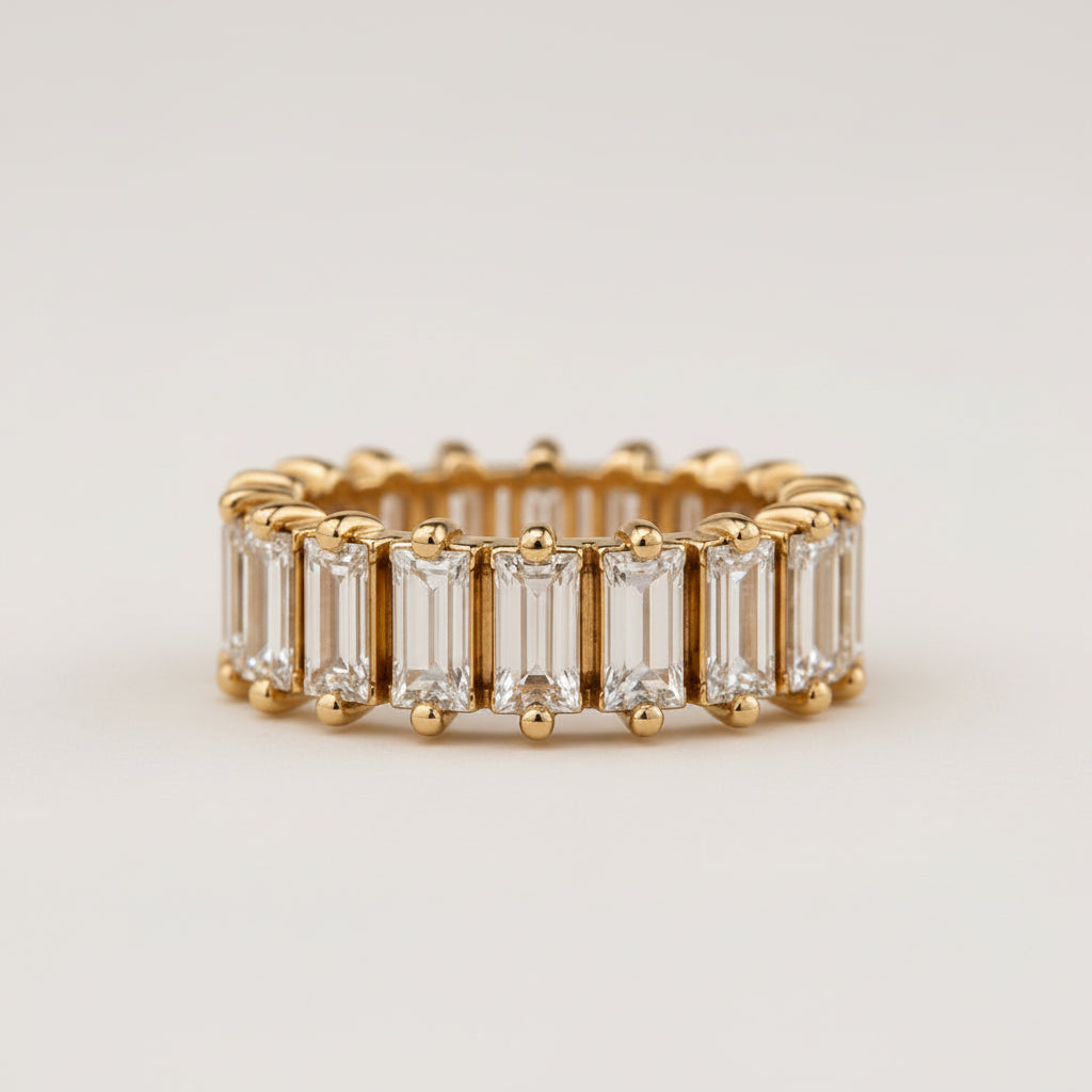 Gold ring with baguette-cut diamonds on a light beige background